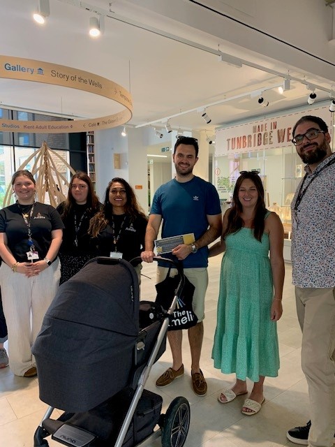 Six-day-old Sienna and her parents being presented with a voucher for being the millionth visitor to the Amelia Scott